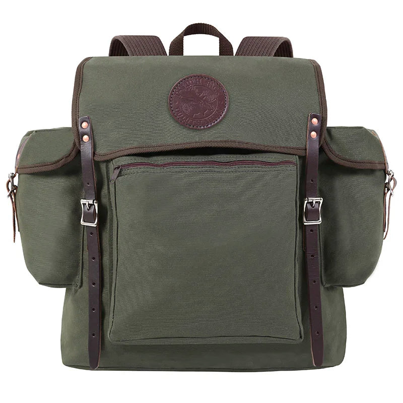 Rambler backpack in Olive Drab canvas with leather straps, rugged and handmade for durable outdoor use by Duluth Pack on hiking and camping trips.