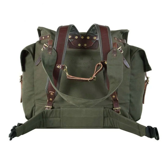 #4 Monarch Pack in olive green canvas with brown leather straps and brass hardware, designed for rugged outdoor use and durable travel by Duluth Pack.