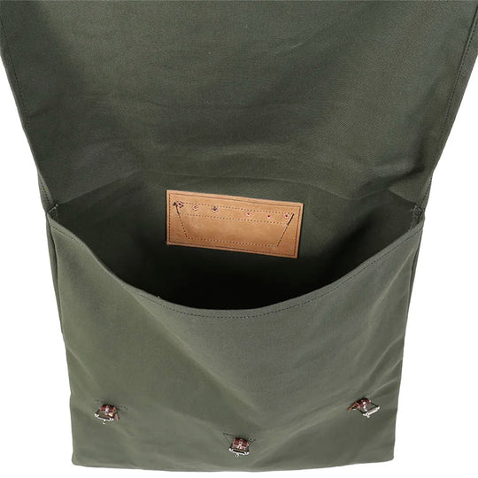 #60 Utility Pack - 42 L in Waxed Olive Drab canvas showing open main compartment with leather label inside, showcasing durable, handmade craftsmanship for outdoor use.