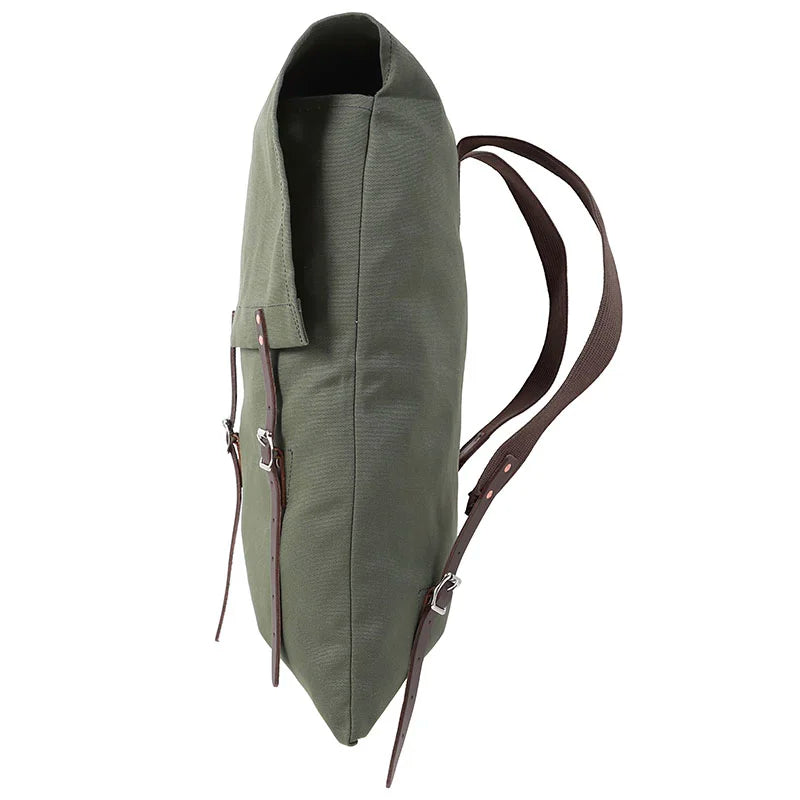 #60 Utility Pack - 42 L in Waxed Olive Drab canvas with reinforced cotton shoulder straps, showcasing durable outdoor craftsmanship by Duluth Pack in a side profile view.